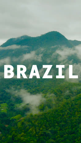 Vertical-Video-Drone-Shot-Of-Rainforest-And-Jungle-Landscape-Overlaid-With-Animated-Graphic-Spelling-Out-Brazil